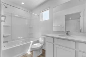 Full bathroom with vanity, toilet, bathing tub / shower combination, and hardwood / wood-style floors