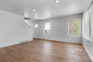 Empty room with hardwood / wood-style floors