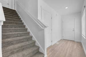 Staircase featuring hardwood / wood-style floors