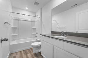 Full bathroom featuring shower / washtub combination, toilet, LVP flooring, and vanity