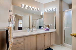 Bathroom featuring vanity and an enclosed shower