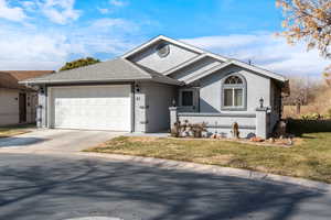 View of front facade with a garage and a front yard