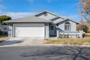 View of front of property featuring a garage and a front yard