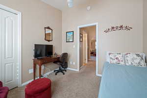 Carpeted bedroom with a closet