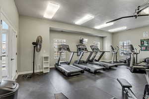 Clubhouse Gym featuring plenty of natural light and a textured ceiling