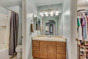 Master Bath/Closet Full bathroom with vanity, shower / bathtub combination with curtain, a textured ceiling, and toilet