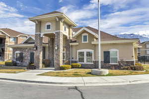 Clubhouse: View of front of club house featuring a mountain view and a front lawn