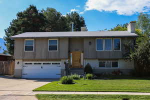 Street view showing two car garage and beautiful front door.