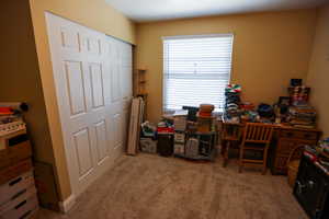 Home office featuring light carpet