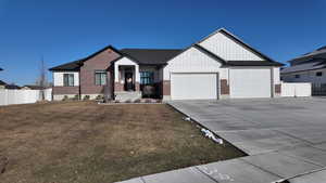 View of front facade with a garage and a front lawn