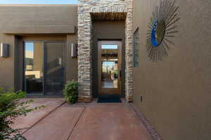 View of exterior entry with a patio