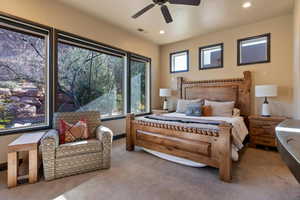 Bedroom with light carpet and ceiling fan