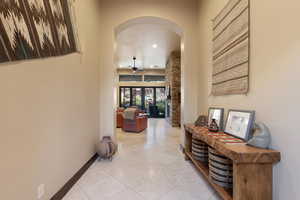 Hallway featuring light tile patterned floors