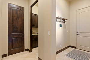 Foyer featuring light tile patterned floors and sink