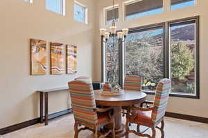 Tiled dining space featuring a notable chandelier