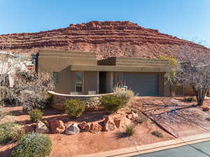 View of front of property featuring a garage and a mountain view