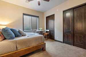 Bedroom featuring light carpet, a closet, and ceiling fan