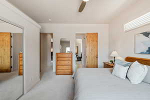 Bedroom with light colored carpet and ceiling fan