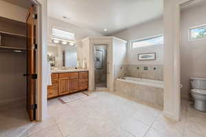 Full bathroom with a healthy amount of sunlight, toilet, tile patterned flooring, and vanity