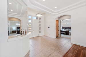 Tiled foyer entrance with a tray ceiling