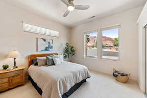 Bedroom featuring ceiling fan and carpet