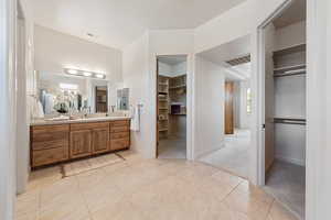 Bathroom with tile patterned floors and vanity