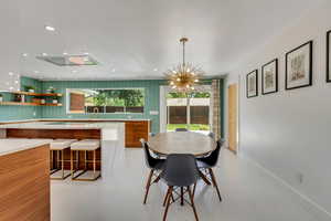 Dining room with sink and an inviting chandelier