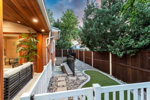 Yard at dusk featuring outdoor lounge area