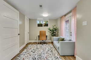 Living area with light hardwood / wood-style flooring