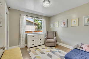 Bedroom with light hardwood / wood-style flooring