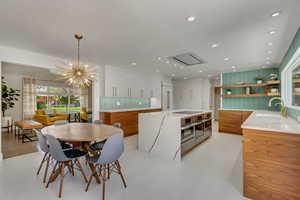 Dining space with sink and a chandelier