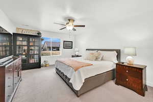 Bedroom with light colored carpet and ceiling fan