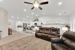 Living room featuring lofted ceiling and ceiling fan