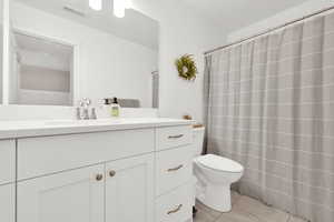 Bathroom with tile patterned floors, toilet, and vanity