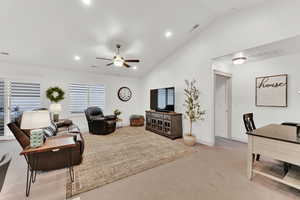 Living room featuring lofted ceiling, light colored carpet, and ceiling fan