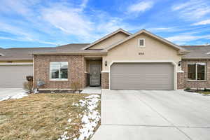 View of front of house with a garage and a front lawn