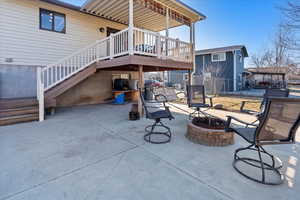 View of patio / terrace with a wooden deck and an outdoor fire pit