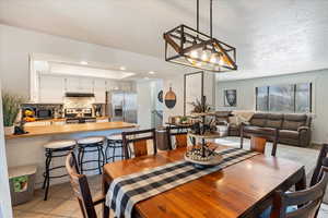 Tiled dining space with a textured ceiling