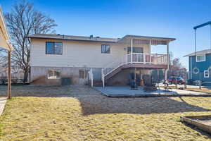 Back of house with central AC and a patio