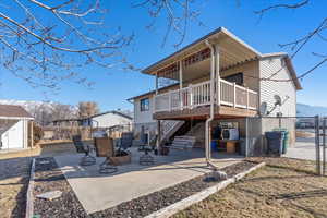 Rear view of property featuring a shed, central AC, an outdoor fire pit, a patio area, and a deck with mountain view