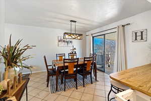 Tiled dining room with a textured ceiling