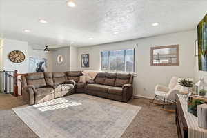 Living room with light carpet and a textured ceiling