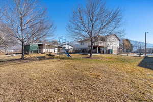 View of yard with a playground and a mountain view