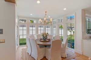 Dining room featuring light hardwood / wood-style flooring and a notable chandelier