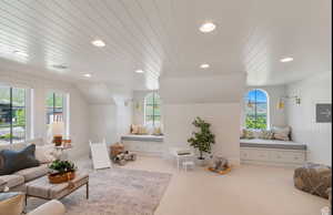 Carpeted living room featuring plenty of natural light and wooden ceiling