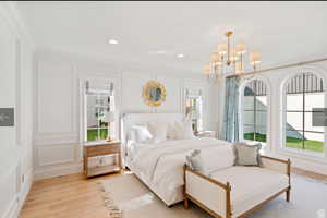 Bedroom featuring crown molding, an inviting chandelier, and light hardwood / wood-style flooring