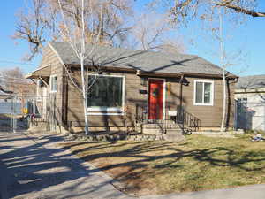 Bungalow-style house with a front lawn