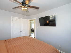 Unfurnished bedroom featuring ceiling fan and a closet