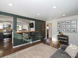 Living room with dark hardwood / wood-style floors