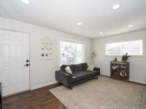 Living room featuring dark hardwood / wood-style flooring and a wealth of natural light